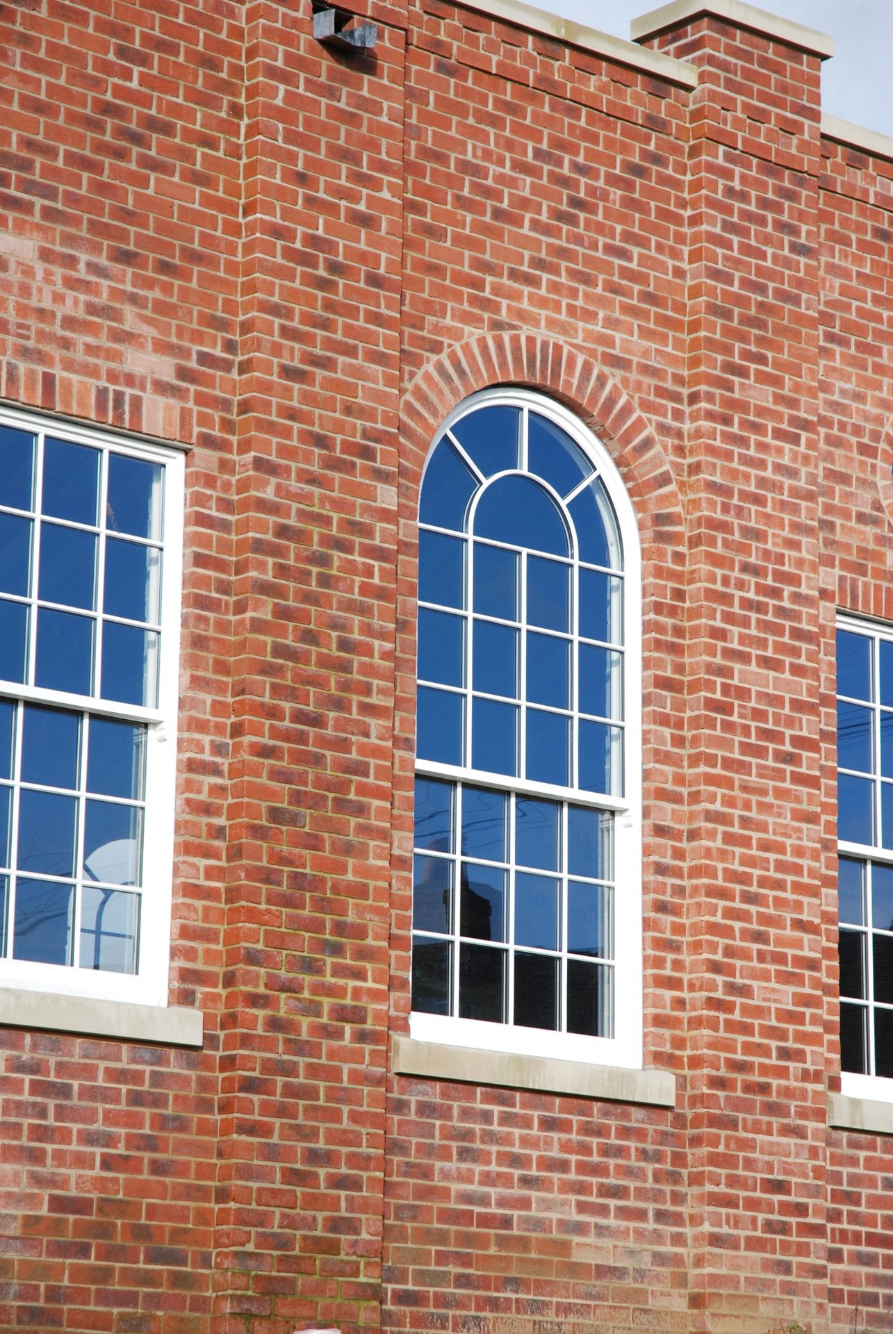 an arched spiral window made from sustainable wood by Gowercroft