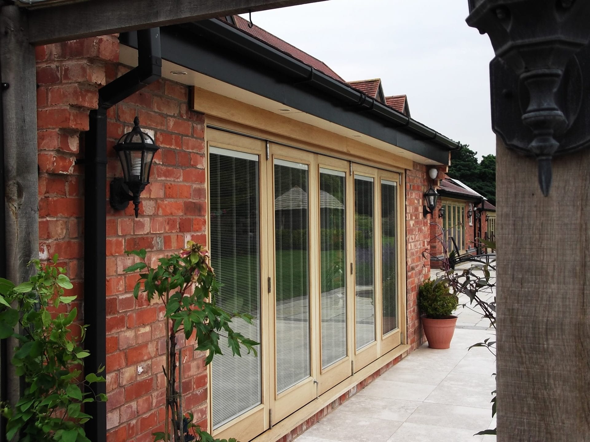 Wooden lift and slide doors looking over a nice patio