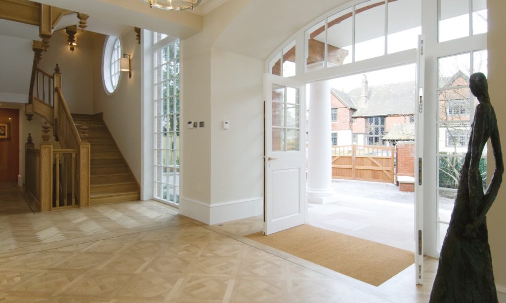beautiful grange road entrance showing stunning timber doors and staircase