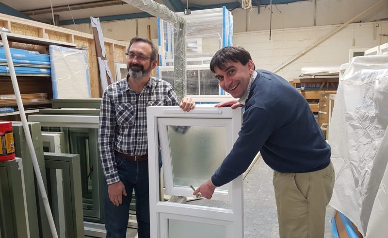 The directors show off a wooden window with lovely ironmongery