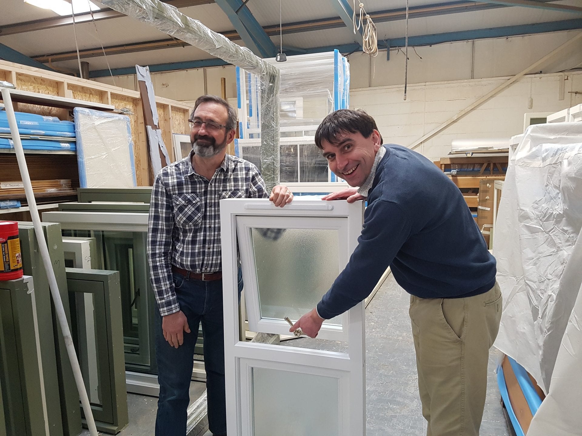 The directors show off a wooden window with lovely ironmongery