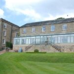 garden of hall with huge length of wooden windows all very stylish