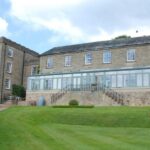 garden of hall with huge length of wooden windows all very stylish