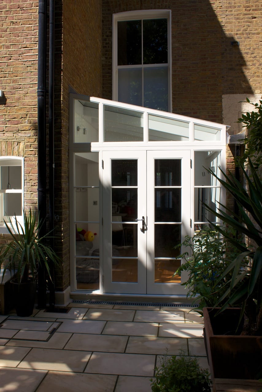 White painted conservatory garden room french doors angled screen