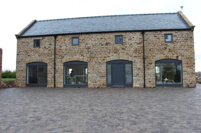 Low angle photo of Dunston barn with modern windows for barn conversions