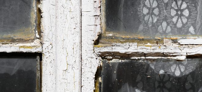 A rotted wooded window in a conservation area in need of replacement