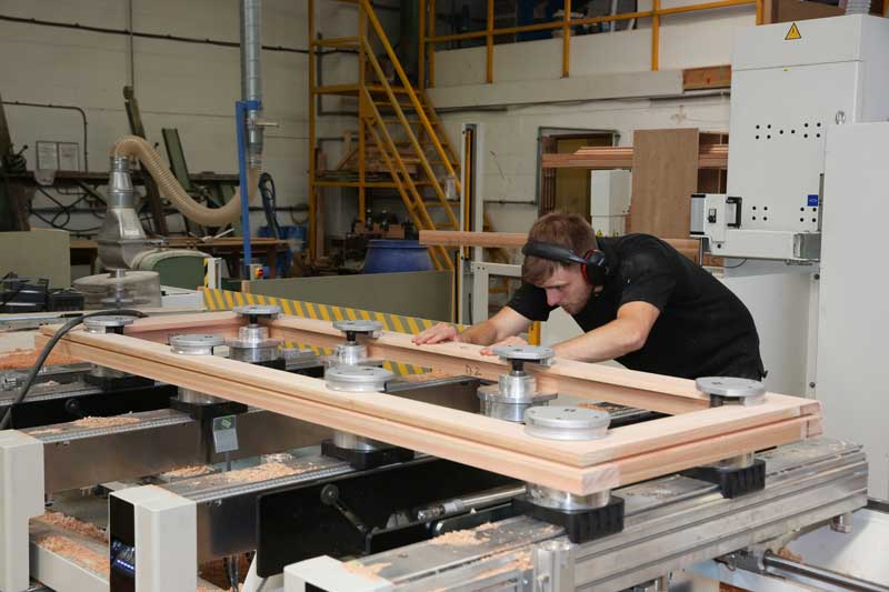 A heritage window company skilled worker making a window