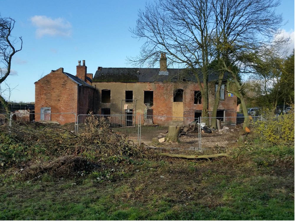 Canal Side Cottages: long shot of the cottages in a state of disrepair before restoration
