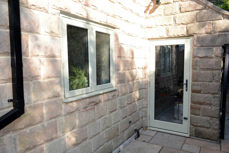 side entrance - timber window and timber entrance door in a cottage in matlock
